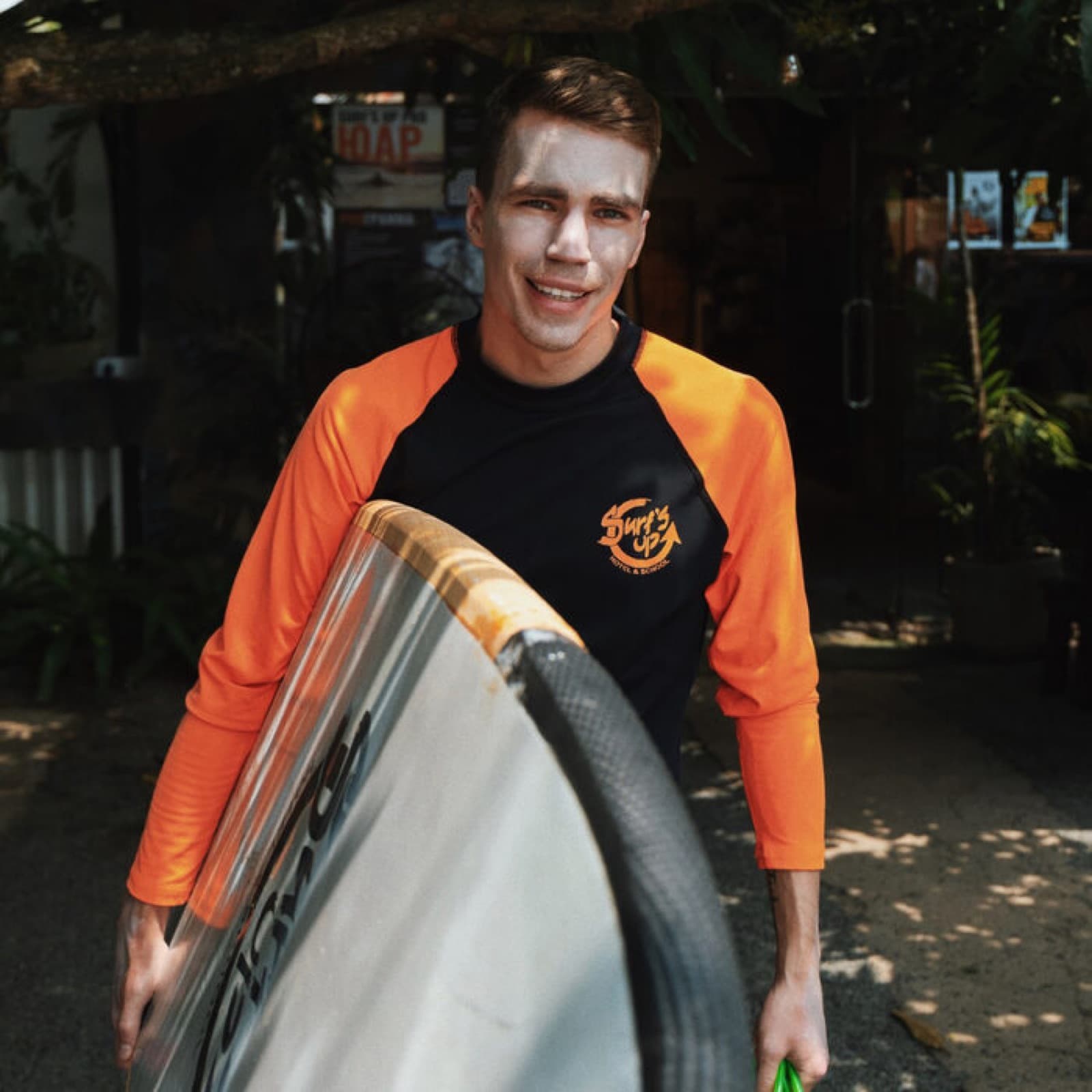 Surf's Up instructor with a board